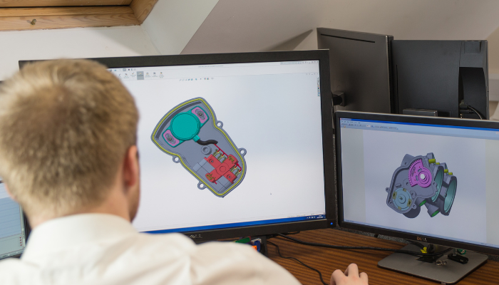 An engineer working on a CAD/Solidworks drawing